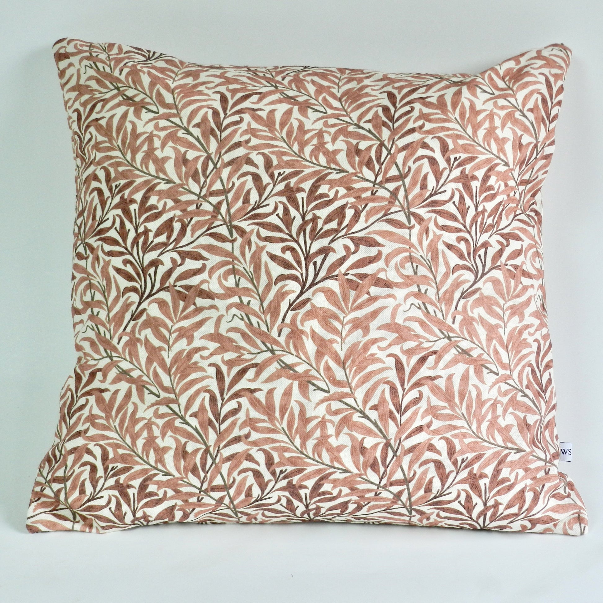 Decorative pillow with leaf pattern on a light blue background