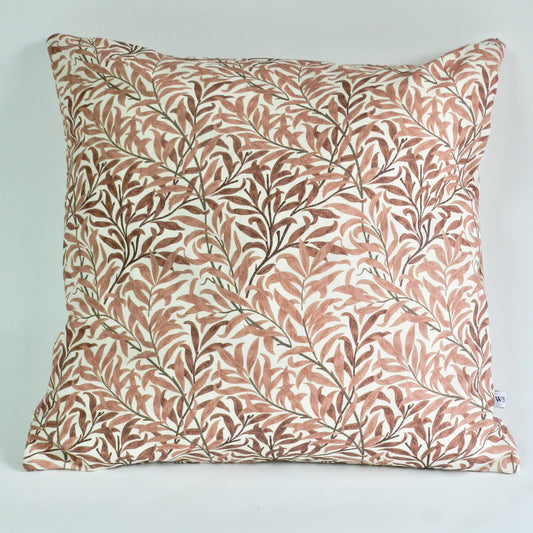 Decorative pillow with leaf pattern on a light blue background