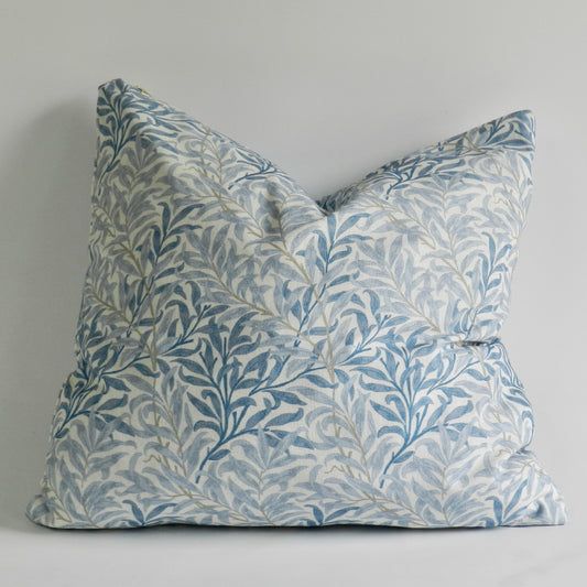 Decorative pillow with leaf pattern on a plain background